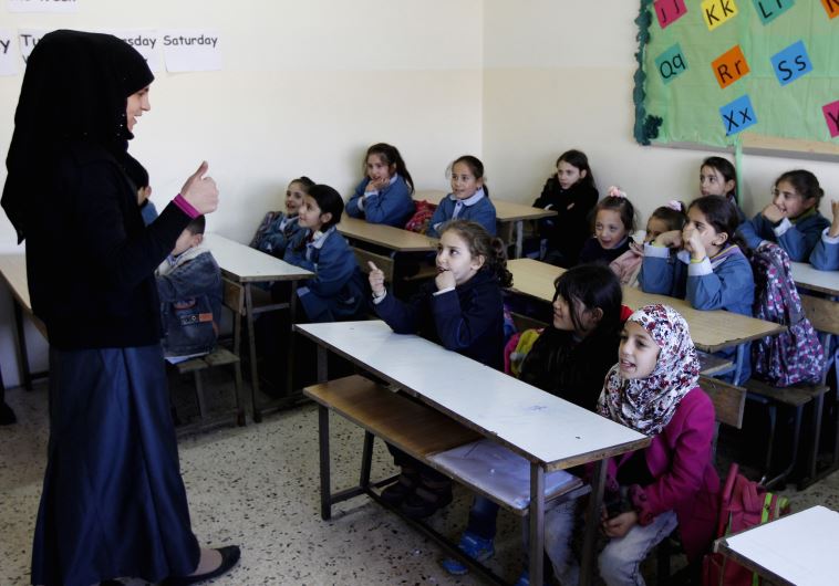 Syrian refugee children attend a lesson in their classroom, Lebanon