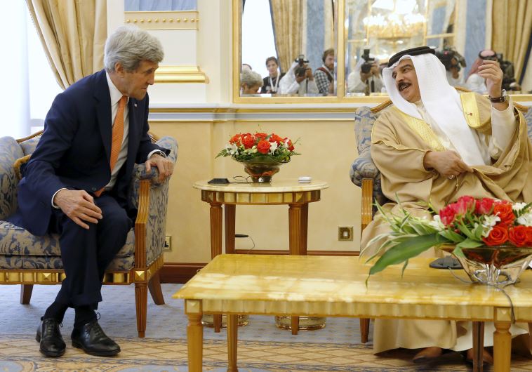 Bahrain's King Hamad bin Isa al Khalifa welcomes U.S. Secretary of State John Kerry at Gudaibiya Pal
