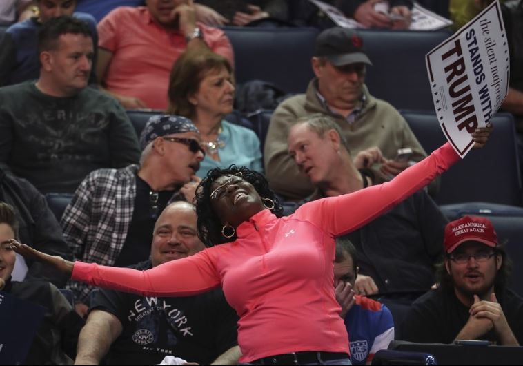 A woman dances before US Republican presidential candidate Donald Trump speaks at a campaign event
