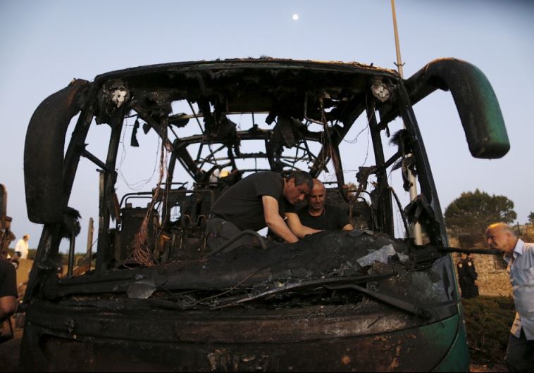 Israeli police forensic experts work at the scene after an explosion tore through a bus in Jerusalem