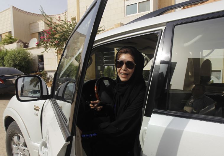 Female driver Azza Al Shmasani alights from her car after driving in defiance of the ban in Riyadh J