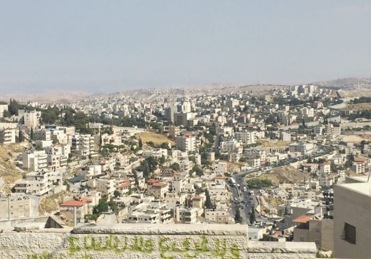 A VIEW from a-Tur of Arab neighborhoods in east Jerusalem, with Abu Dis, beyond the security barrier