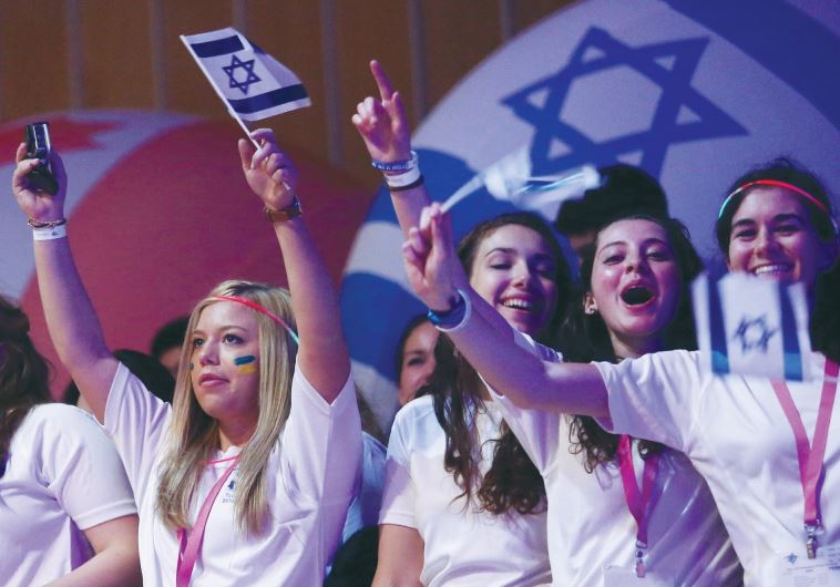 Birthright participants wave flags and cheer during a recent event in Jerusalem.