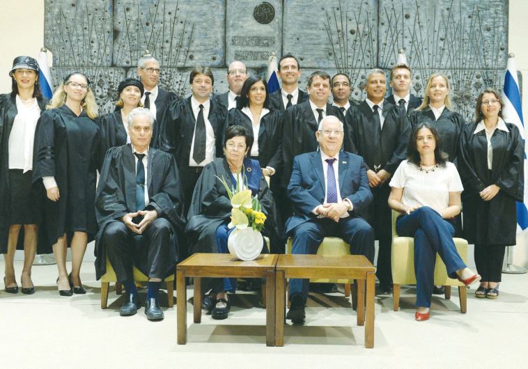 PRESIDENT REUVEN RIVLIN (seated, second from right) poses in front of newly appointed judges and reg