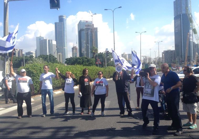 Vicki Knafo (third from left) leads a march of handicapped and financially disadvantaged persons in 