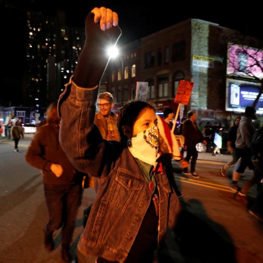 Demonstrators march as they shout slogans against President-elect Donald Trump in Minneapolis