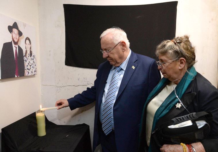 Rivin lights memorial candle at Mumbi Chabad House