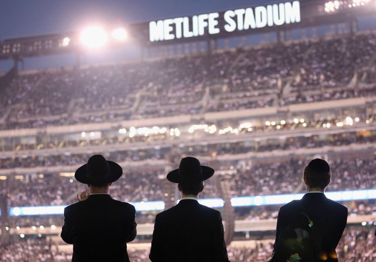 Orthodox Jews gather to celebrate the completion of study of the entire Talmud religious text