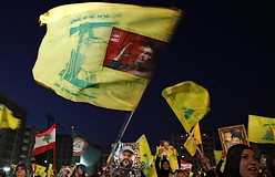 Hizbullah supporters wave Hizbullah flags during a