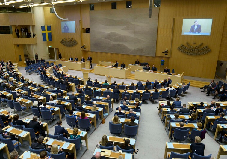 Sweden's Prime minister Stefan Lofven (standing C) announces his new government during a Parliament 