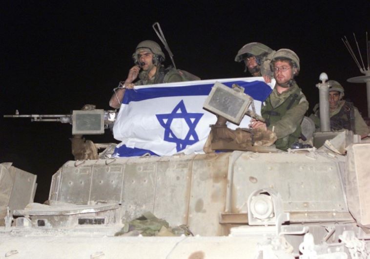 Israeli soldiers crossing the border with Lebanon into Israel on an armoured personal carrier