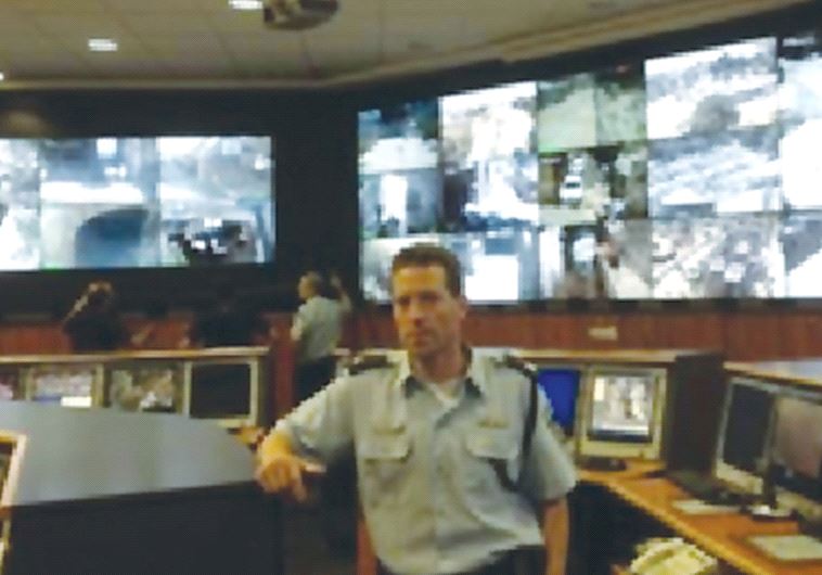POLICE SPOKESMAN Micky Rosenfeld stands inside the state-ofthe- art police headquarters, Mabat 2000,