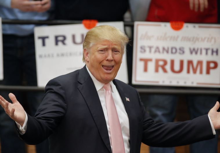 US Republican presidential candidate Donald Trump reacts to supporters 