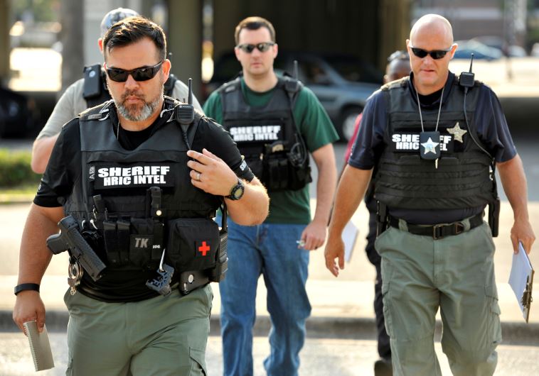 Officers arrive at the Orlando Police Headquarters during the investigation of a shooting at the Pul