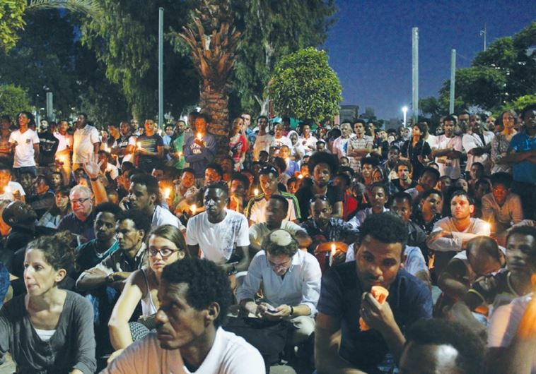MOURNERS HOLD a candle-light vigil for Eritrean Haptom Zarhum in Tel Aviv’s Levinsky Park last night