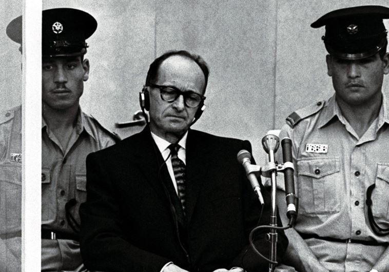 Israeli police flank Adolf Eichmann, the Nazi SS colonel who headed the Gestapo's Jewish Section 