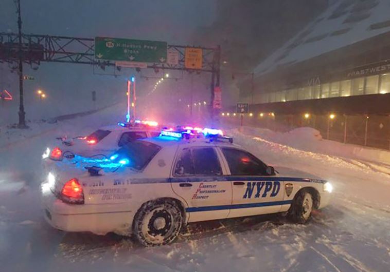 New York City police monitor traffic during a heavy snowstorm, in New York January 23, 2016.