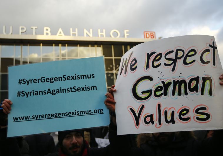 People from Syria hold placards reading 'Syrians against sexism' during a rally outside the main rai