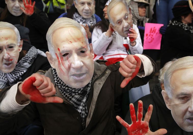 Anti-Israel demonstrators led by the protest group Code Pink wear masks of Prime Benjamin Netanyahu 