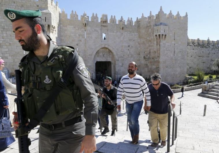  Caption: Washington Post bureau chief William Booth and Sufian Taha are escorted by police outside 