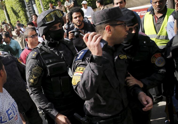 Egyptian protesters shout slogans and argue with police during a demonstration 
