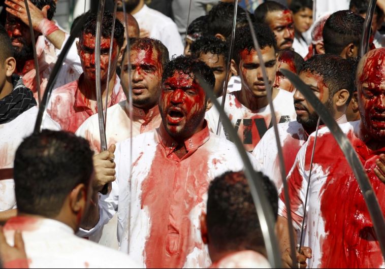 Shi'ite Muslims march on streets with swords during Ashura procession in downtown Manama, Bahrain