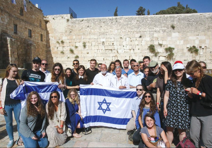 DEPUTY FOREIGN MINISTER Tzipi Hotovely (standing behind left corner of flag) and the three paratroop