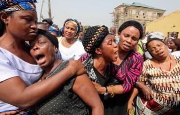 Nigerian women weep after Christmas Day bombing.