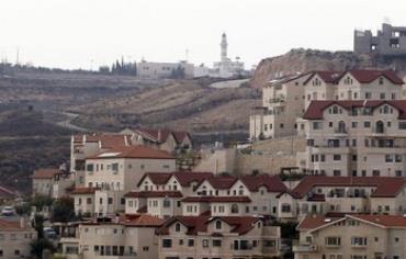 Mosque in Abdullah Ibrahim behind houses in West Bank Jewish settlement of Efrat, December 2011. 