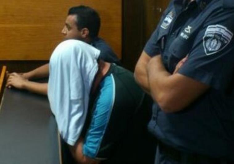 LGBT activist connected with the Bar Noar murders, Shaul Ganon, covers his head in the court room.