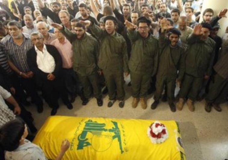 Supporters of Hezbollah and relatives gesture during a funeral.