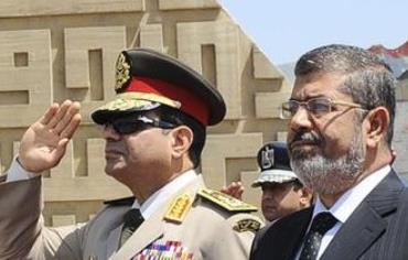 Egypt'sChief of Staff Abdel Fattah al-Sisi (R) and Egyptian President Mohamed Morsi in April, 2013.