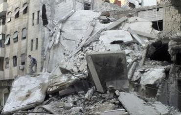 Rubble of buildings damaged by shelling by Assad's forces in besieged area of Homs July 4, 2013. 