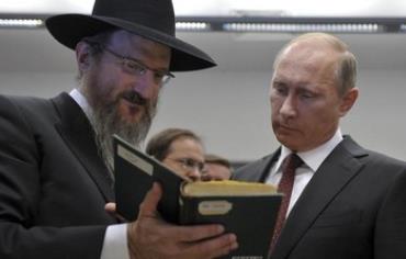 Russia's President Vladimir Putin listens to Russia's Chief Rabbi Berel Lazar at tolerance center.
