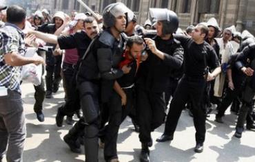 Police detain a supporter of Morsi during clashes in central Cairo August 13, 2013. 