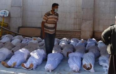 Syrian activists inspect bodies of people they say killed by nerve gas in Damascus August 21, 2013