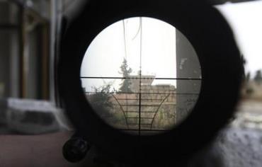 A Syrian regime gathering point is seen through a sniper scope