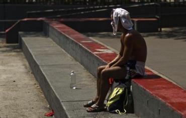 A man rests during a heat wave.