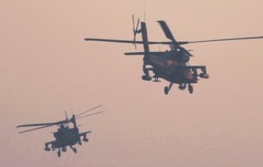 Egyptian Apache helicopters fly over Tahrir Square in Cairo