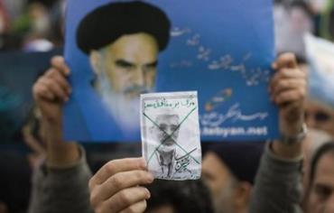 A worshiper holds a picture of opposition leader Mirhossein Mousavi.