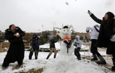 Girls have a snowball fight in Jerusalem, December 12, 2013.