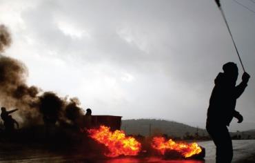Palestinians confront Israeli troops at the West Bank village of Silwad, near Ramallah, on January 1