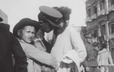 BRITISH POLICE officers corral Jewish men during the 1920 Jerusalem riots