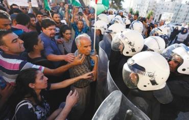 PALESTINIAN RIOT police face civilians protesting security coordination between the PA and Israel in