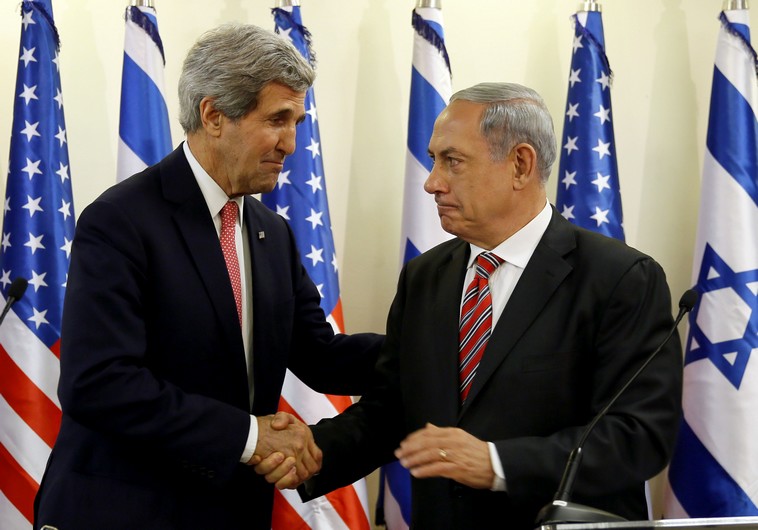 Prime Minister Benjamin Netanyahu (R) shakes hands with US Secretary of State John Kerry