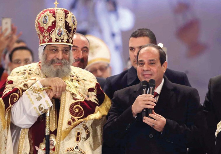 EGYPTIAN PRESIDENT Abdel Fattah al-Sisi speaks next to Coptic Pope Tawadros II