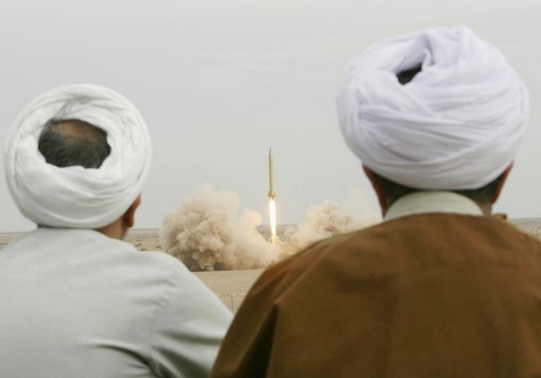 Iranian clerics watch the firing of a Shahab-3 missile during a war game in a desert near Qom