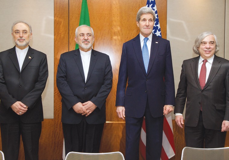 US AND IRANIAN negotiators pose yesterday in Geneva before a discussion of Iran’s nuclear program