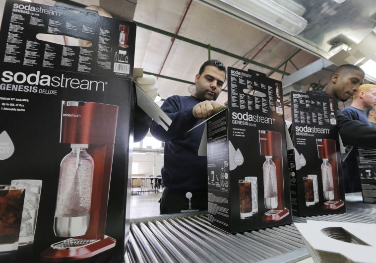 Employees pack boxes of the SodaStream product at the factory in Maaleh Adumim