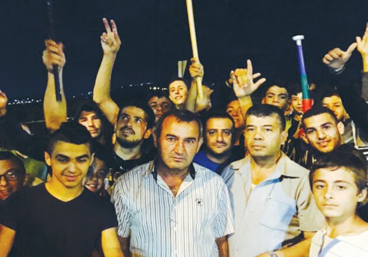 JABER HAMOUD (second left), head of the Druse and Circassian Local Councils Forum, protests in Sajur